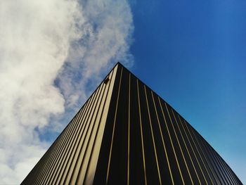 Low angle view of modern building against blue sky