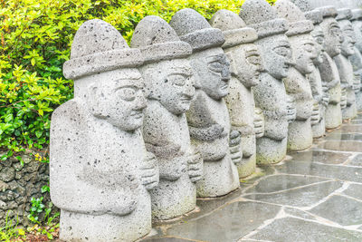 Statues on stone wall