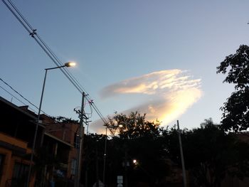 Low angle view of illuminated building against sky during sunset