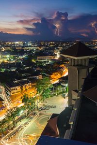 High angle view of illuminated buildings in city at night