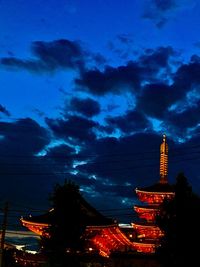 Low angle view of illuminated buildings against sky at dusk