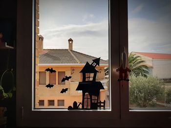 House against sky seen through window