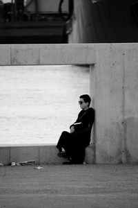 Rear view of man sitting on steps