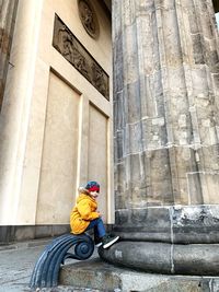 Side view of man riding bicycle on building