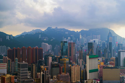 Aerial view of buildings in city against sky