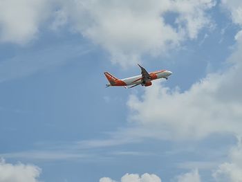 Low angle view of airplane flying in sky