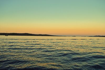 Scenic view of sea against clear sky during sunset