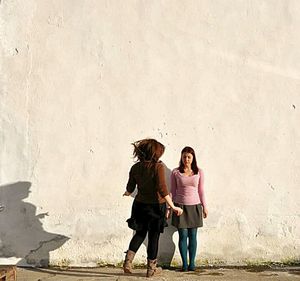 Full length of woman standing on wall