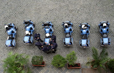 High angle view of police standing by motorcycles on footpath