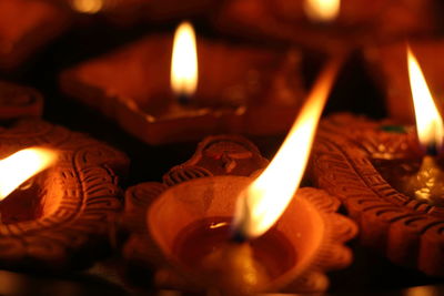 Close-up of lit candles in temple