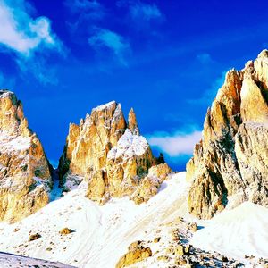 Scenic view of snowcapped mountains against blue sky