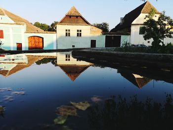 Reflection of building in lake against sky