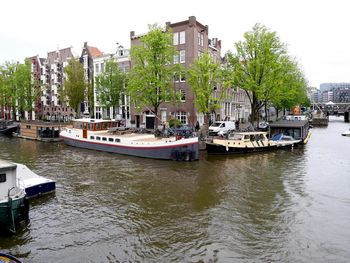 Boats in river with buildings in background