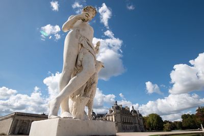 Low angle view of statue against sky