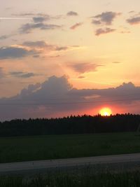 Scenic view of field against sky during sunset