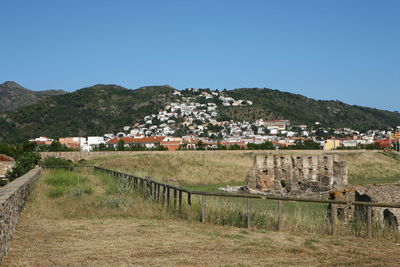 Scenic view of town against clear blue sky