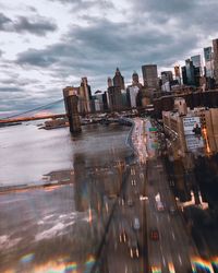 Aerial view of buildings against cloudy sky