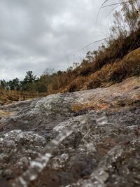 Surface level of river flowing against sky