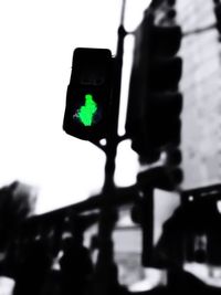 Low angle view of illuminated text on road against sky