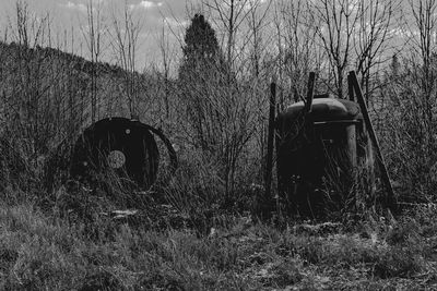 View of old abandoned car on field