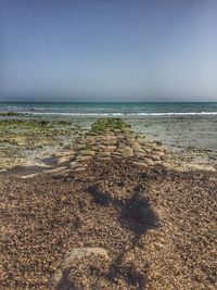 Scenic view of beach against clear sky