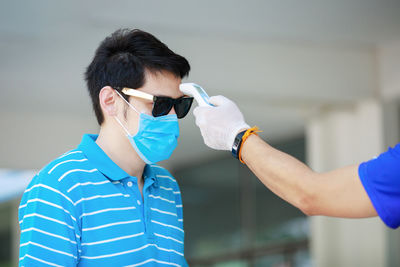 Portrait of man standing against wall