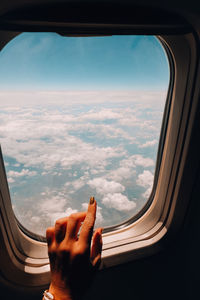 Female hand airplane flight. view from the window of the plane. airplane, aircraft. vacation travel 