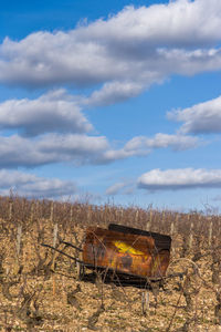 Abandoned truck on field against sky