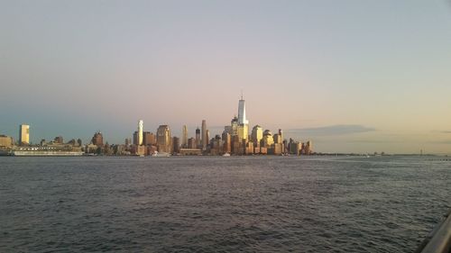 Scenic view of hudson river by city against sky during sunset