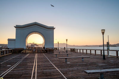 Pier by sea during sunset