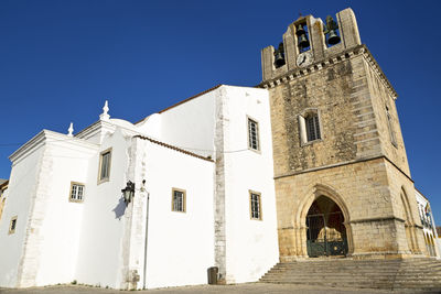 Low angle view of historic building against clear blue sky