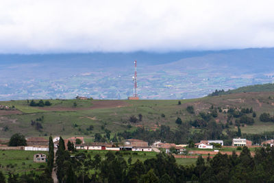 Scenic view of landscape and buildings against sky