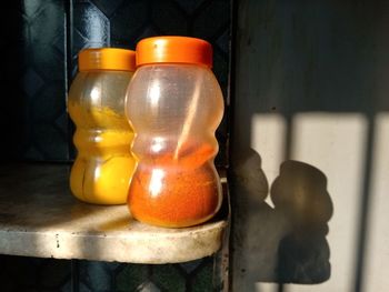 Close-up of orange bottles on table