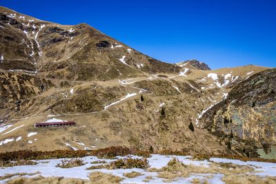 Scenic view of snowcapped mountains against clear blue sky