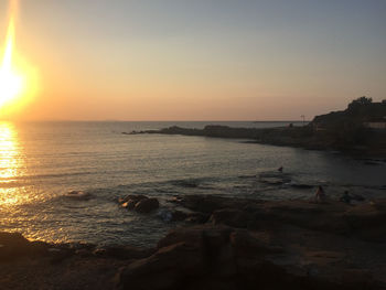 Scenic view of sea against clear sky during sunset