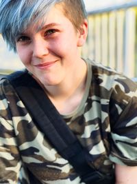 Portrait of smiling hipster woman with highlights in city