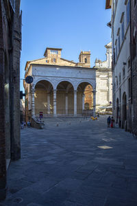 Street amidst buildings in city against sky