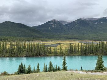 Scenic view of lake and mountains against sky