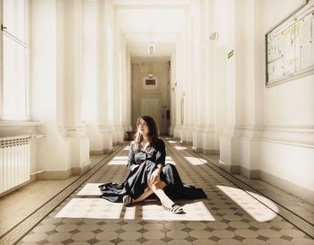 Young woman sitting at home