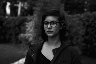 Portrait of young woman wearing eyeglasses at park