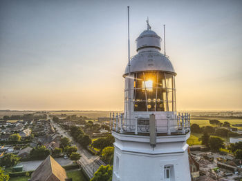 High angle view of illuminated building against sky during sunset