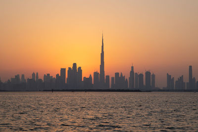 View of buildings in city during sunset