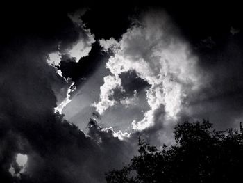 Low angle view of silhouette trees against sky