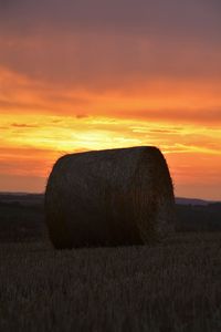 Scenic view of landscape against sky at sunset