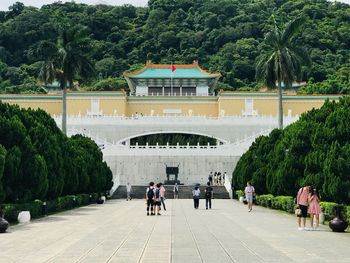 Group of people walking in front of building