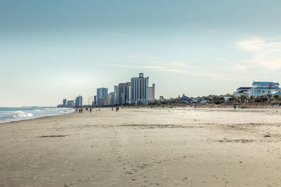 Panoramic view of beach and buildings against sky