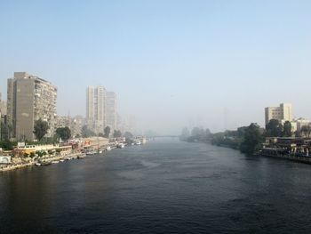 City by river against sky