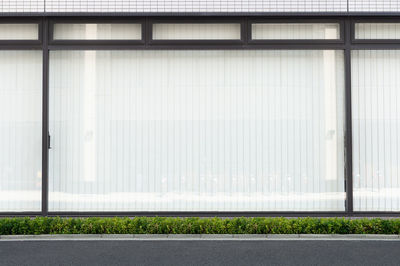 Empty road by building in city