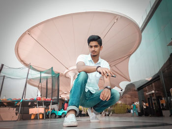 Portrait of young man against sky