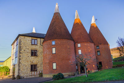 Low angle view of historical building against clear blue sky